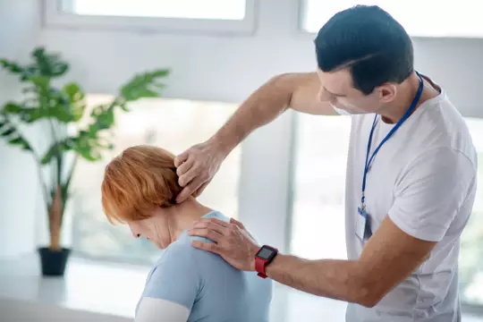 skilled chiropractor therapist touching his patients neck